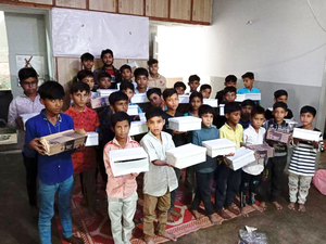 Children holding boxes of shoes.